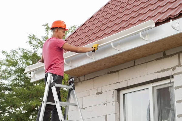 Seamless gutter installation on a house